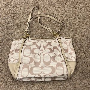 Coach cream/light brown coach logo print purse.  Light purple lining.  Excellent